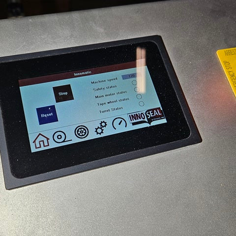 Innomatic touchscreen control panel showing machine speed and status display